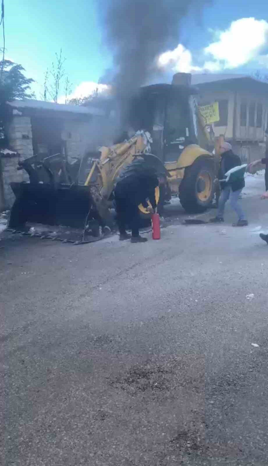 İş makinesinde çıkan yangını karla söndürmeye çalıştılar
